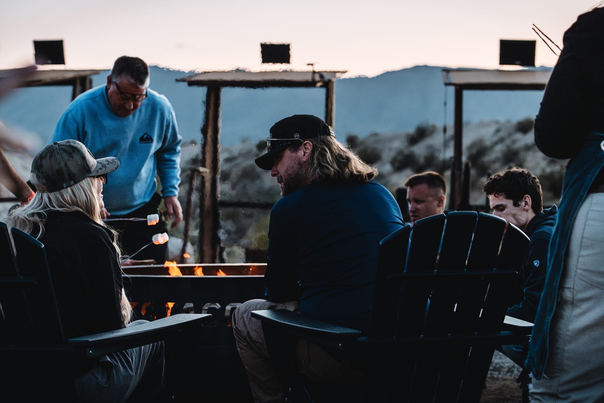 Members around the fire pit at dusk