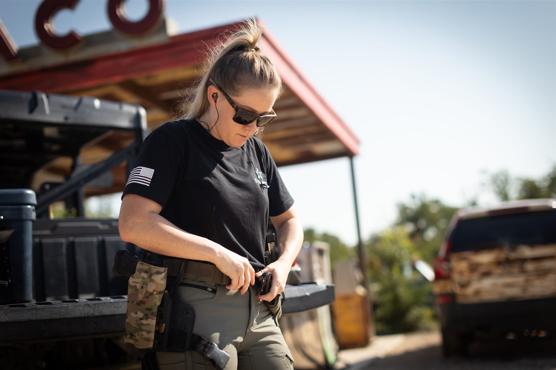 A shooter gearing up beside a truck before a course run