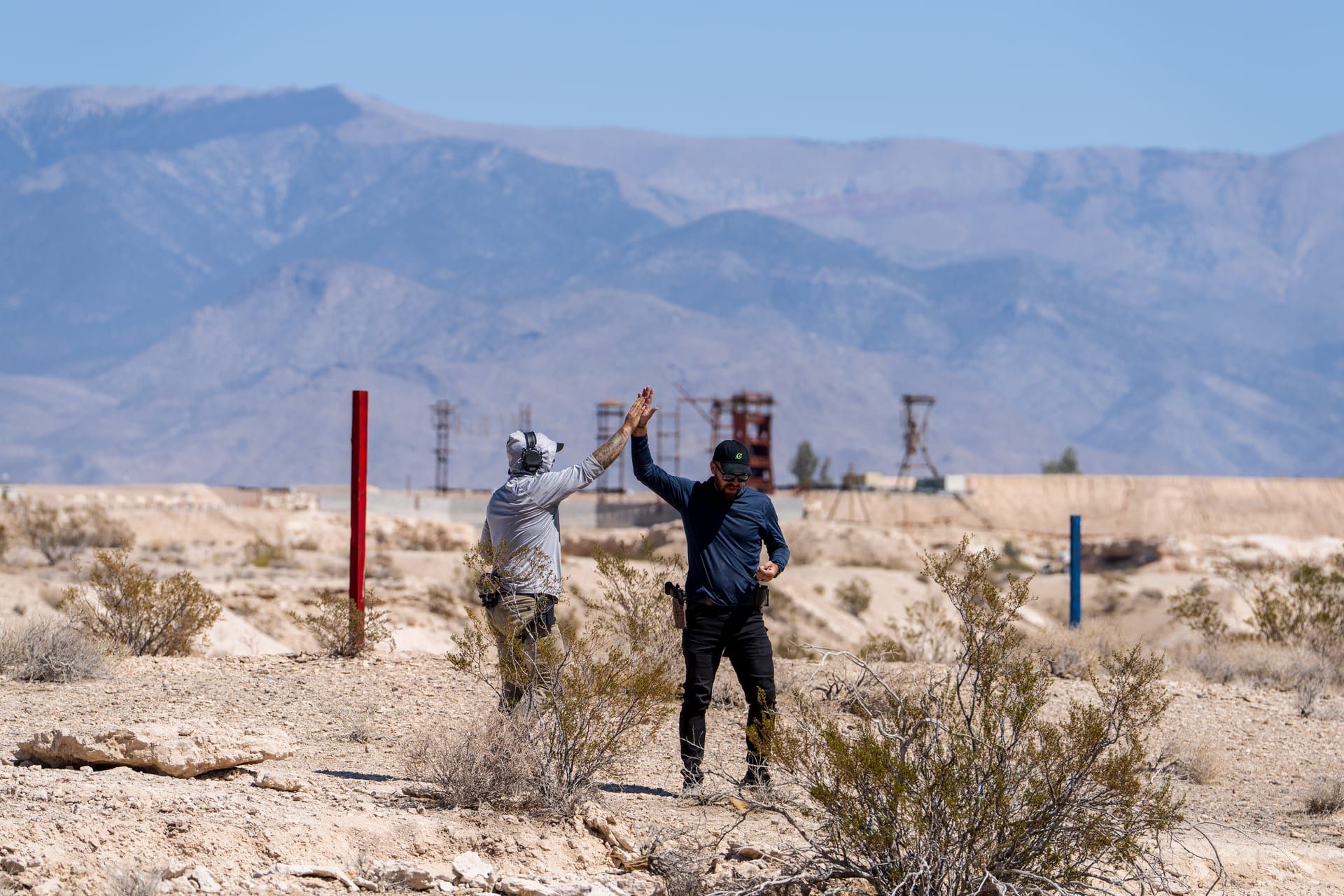 Shooters on a desert bay with the mountains beyond
